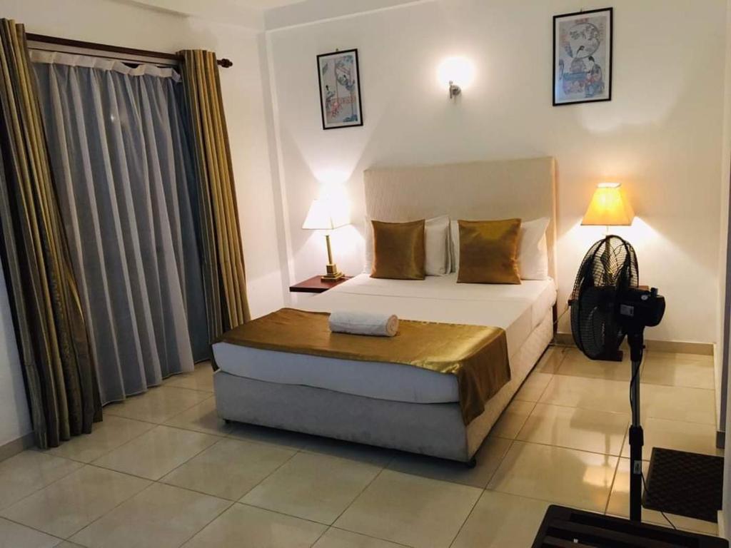 Postel nebo postele na pokoji v ubytování Kandy Highland Unique Hotel