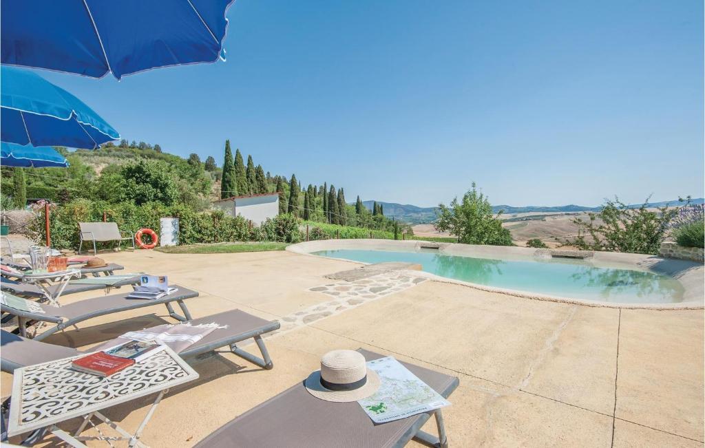 a villa with a swimming pool with chairs and an umbrella at La Casa Della Fata in Montenero