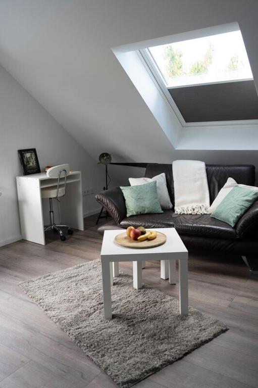 a living room with a couch and a table at Zentrale Ferienwohnung in Bielefeld