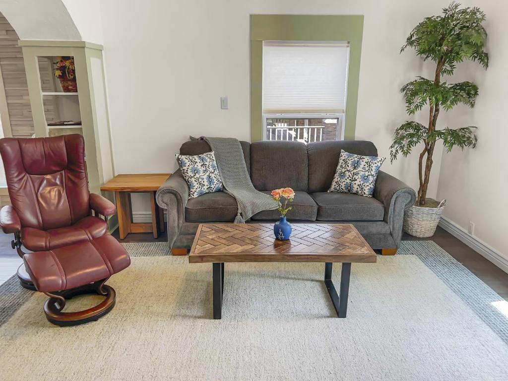 a living room with a couch and a coffee table at Reminiscent Downtown Cottage cottage in Grand Junction