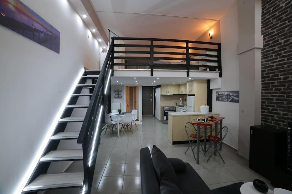 a staircase leading to a living room and a kitchen at loft apartment in Athens