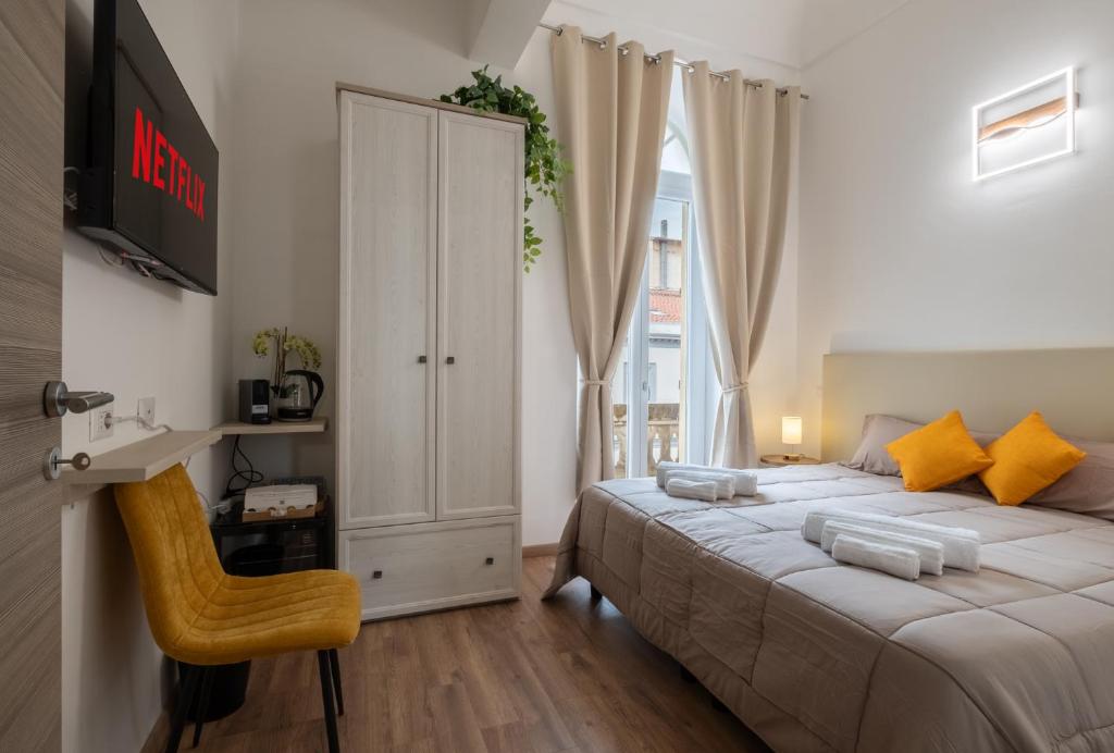 a bedroom with a large bed and a window at Via Roma 106 Apartment in Sassari