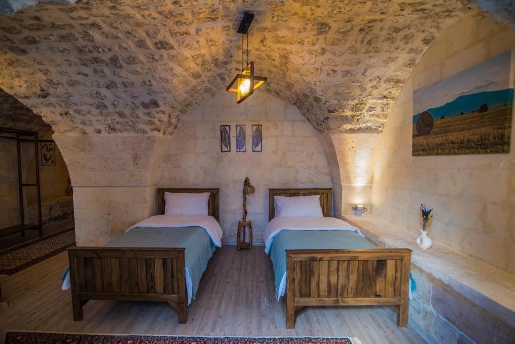 Postel nebo postele na pokoji v ubytování Sarmaşık Otel