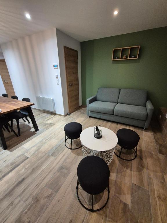 un salon avec un canapé, une table et des chaises dans l'établissement chez Cyril et Celine, à Tignes