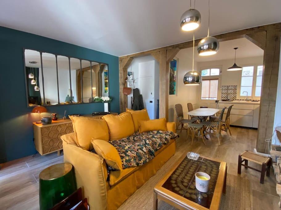 トゥルヴィル・シュル・メールにあるMaison de pêcheursの黄色いソファとテーブルのあるリビングルーム