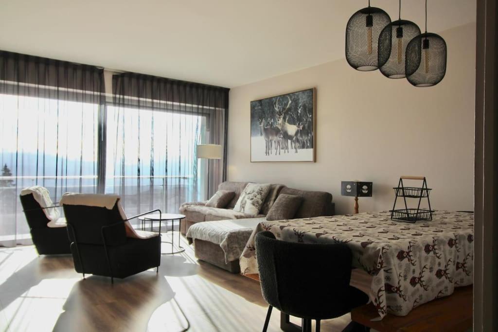 un salon avec un canapé, une table et des chaises dans l'établissement Loft Edelweiss, à Font-Romeu-Odeillo-Via