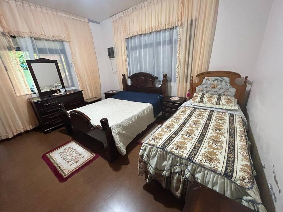 una camera da letto con due letti e uno specchio di Residencial Rosângela - Pantano Grande a Pântano Grande