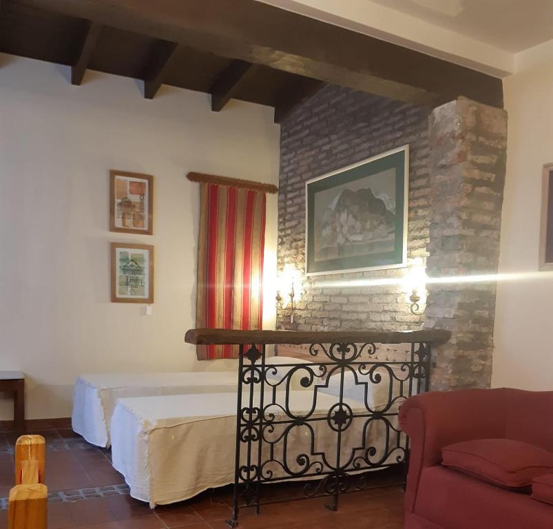 a bedroom with a bed and a brick wall at La Pink House Salta, Monoambiente amplio y cómodo in Salta
