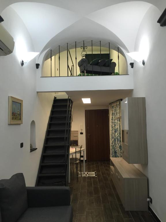 a room with a staircase and a living room at Appartamento al Ponte Reale in Genoa