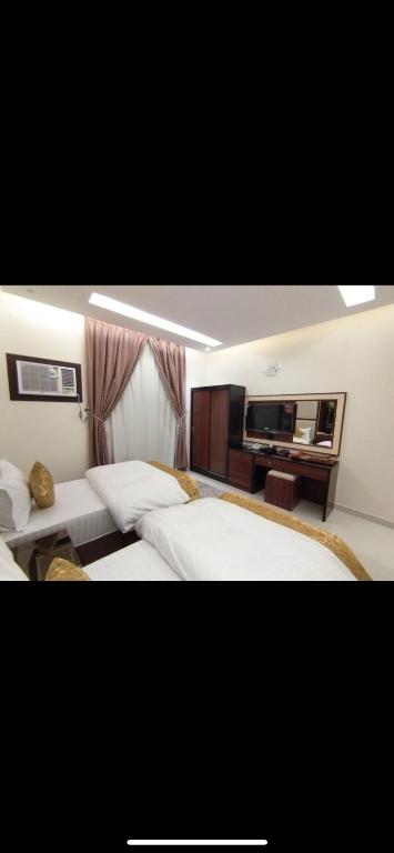 Postel nebo postele na pokoji v ubytování Al Shark Park Serviced Apartment