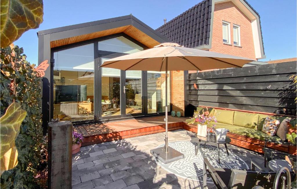 an umbrella sitting on a patio in front of a house at Stunning House In Spakenburg in Spakenburg