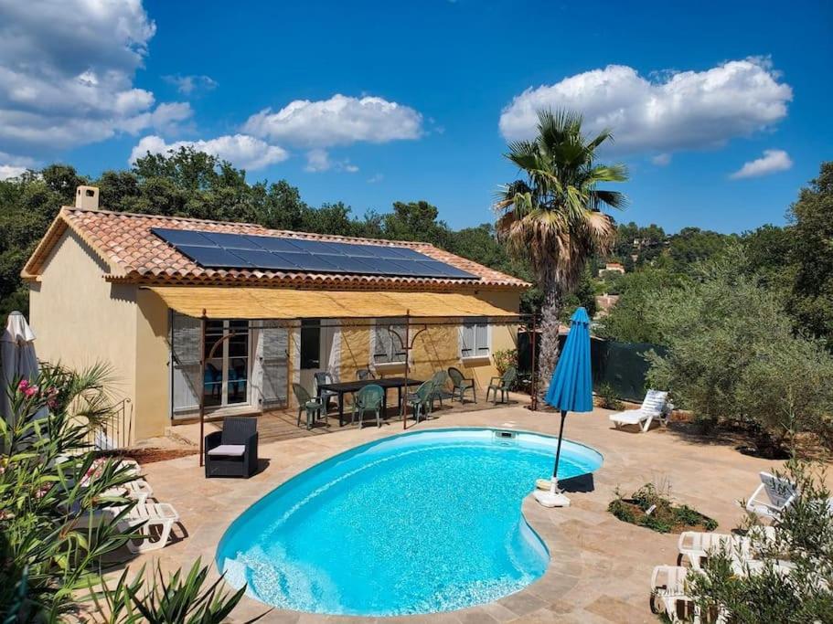 a house with a swimming pool in front of a house at Villa 7 ch, piscine chau,22 pers in Le Thoronet