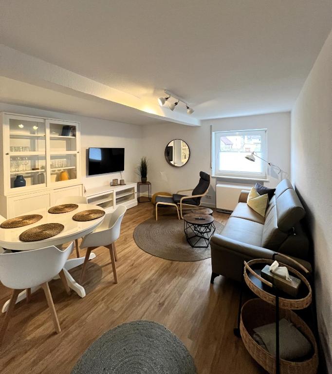 a living room with a couch and a table at FeWo Rehborn in Rehborn