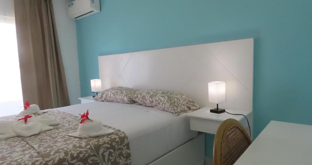 Postel nebo postele na pokoji v ubytování All Seasons Hotel