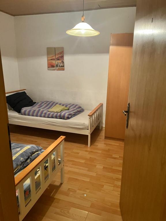 a room with two bunk beds and a door at Unterkunft Dähre in Dähre