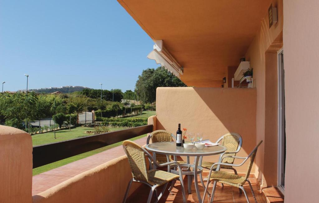 a patio with a table and chairs on a balcony at Casares Del Sol in Casares