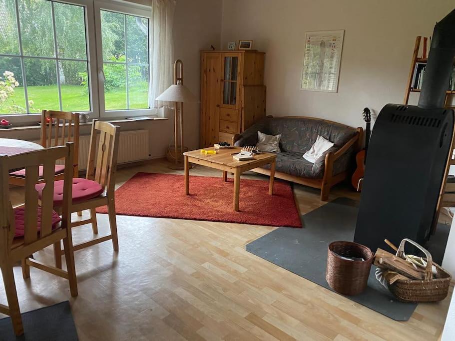 a living room with a couch and a table at Rollstuhlgerechter Ferienbungalow in ruhiger Lage in Bad Harzburg