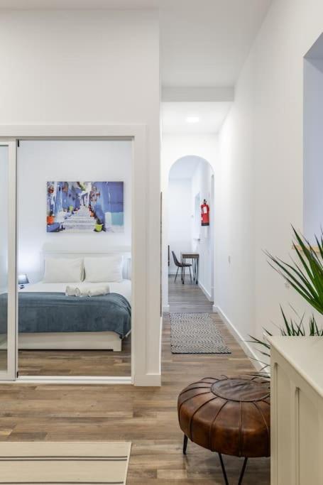 a bedroom with a bed and a chair in a room at Bright apartment with garden in Porto