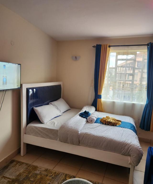 Postel nebo postele na pokoji v ubytování Kiserian Comfort
