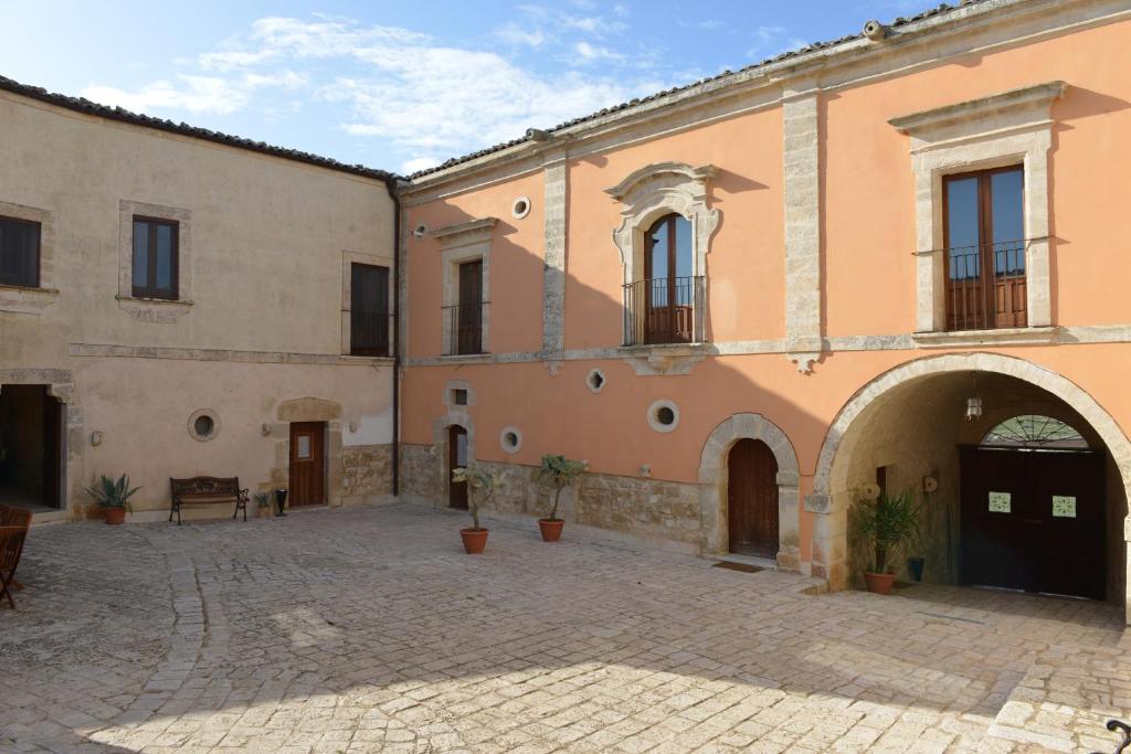 einen Innenhof in einem Gebäude mit Torbogen in der Unterkunft Relais Cimillà B&B in Ragusa