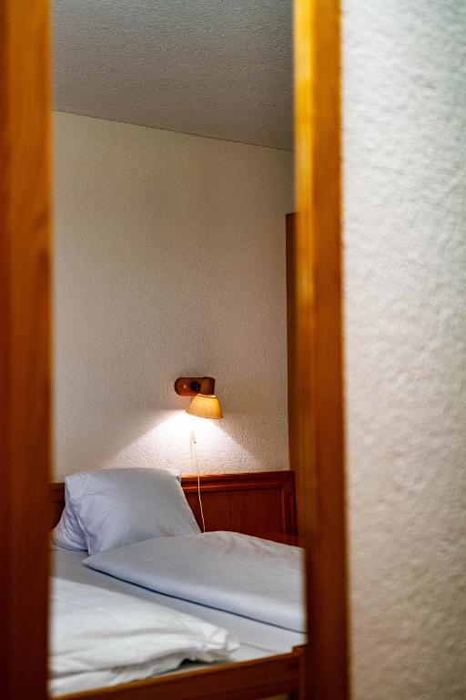 Postel nebo postele na pokoji v ubytování Kurhaus Heiligkreuz