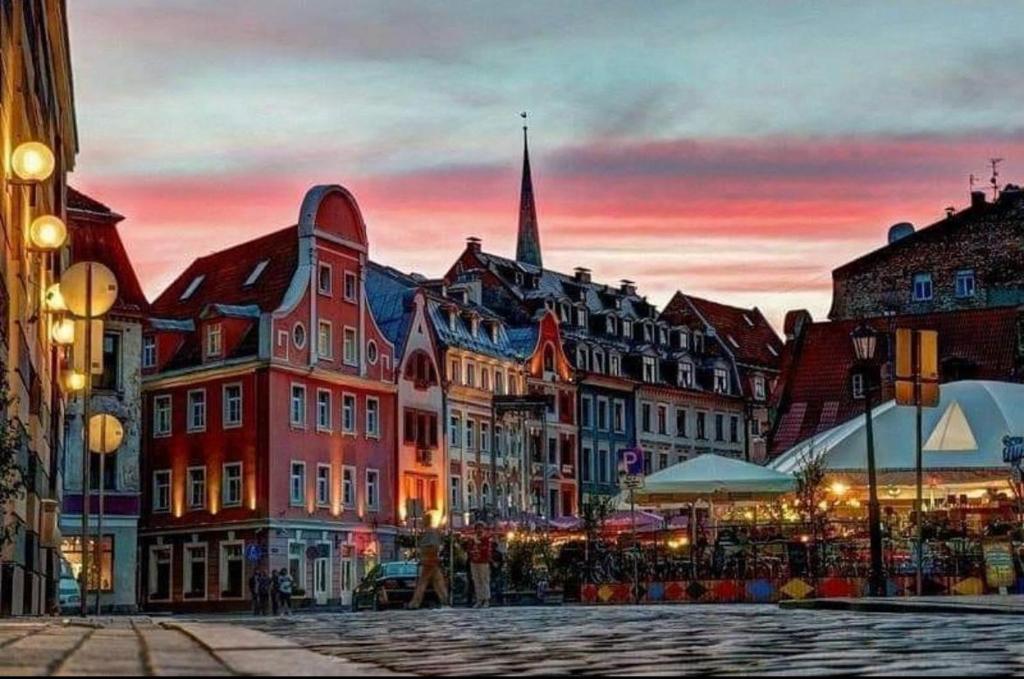 a group of buildings in a city at sunset at Lux-Apartment in Medieval Part of Old Riga in Riga