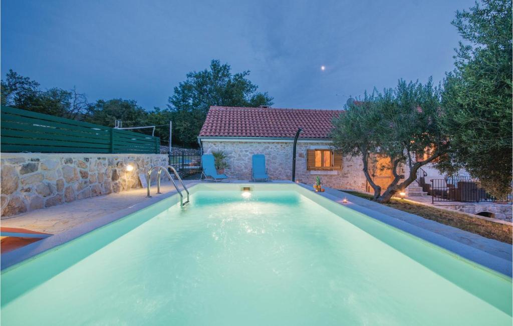 a swimming pool in the backyard of a house at Two-Bedroom Holiday Home In Jagodnja Gornja in Gornja Jagodnja