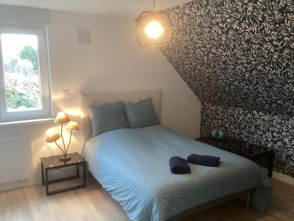 Postel nebo postele na pokoji v ubytování Chambre d hôtes chez Carol et Patrick