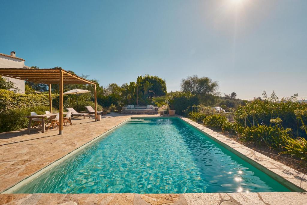 a swimming pool in the backyard of a house at The Guardian House in Santa Gertrudis de Fruitera