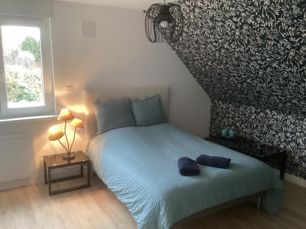 Postel nebo postele na pokoji v ubytování Chambre d hôtes chez Carol et Patrick