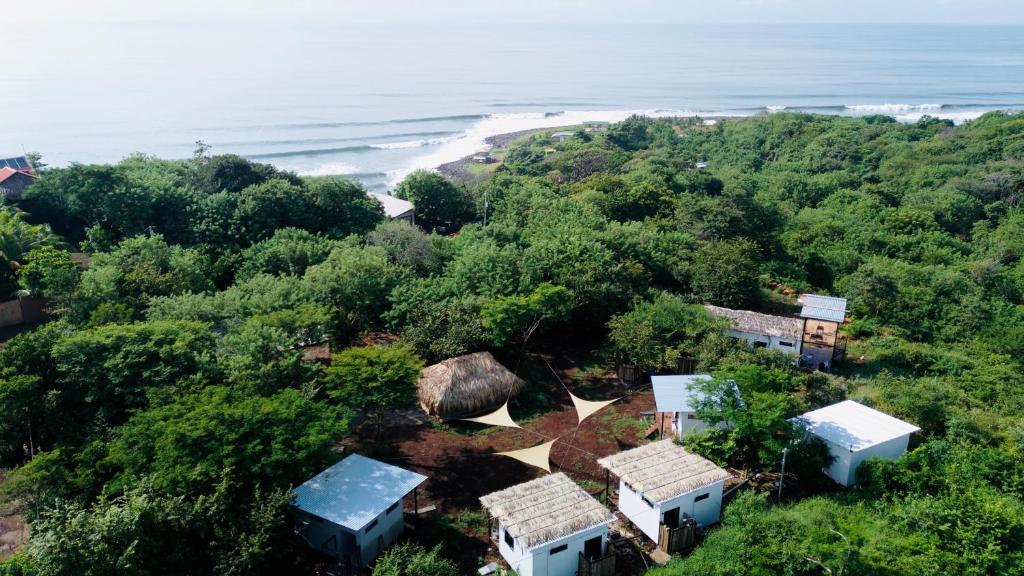an aerial view of a beach with houses and trees at Alma Vita Punta Mango in Jucuarán