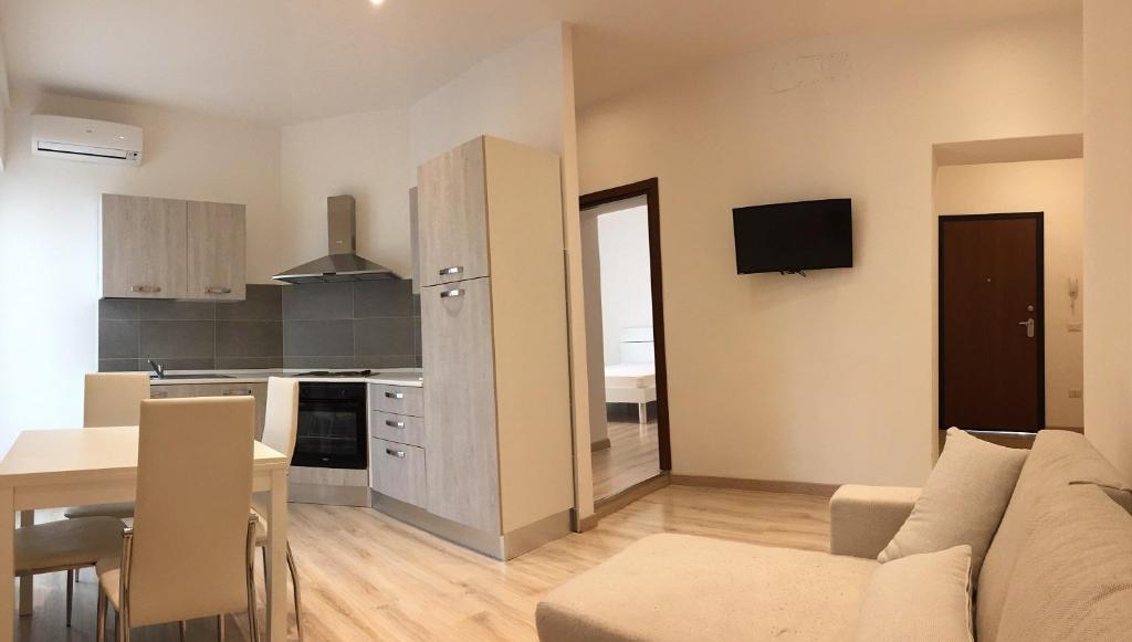 a living room and kitchen with a couch and a table at La Rosa dei Venti in Foligno