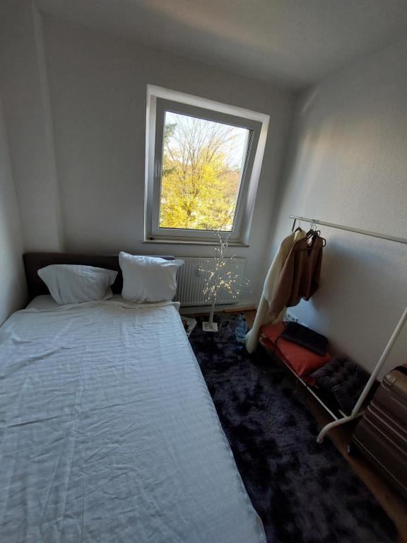 a small bedroom with a bed and a window at Nürnberg&Wellcome in Nürnberg