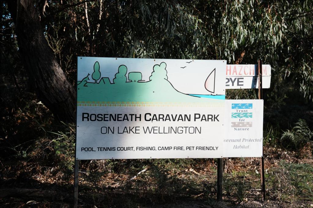 a sign for a recreation caravan park on lake wellington at Roseneath Holiday Park in Meerlieu
