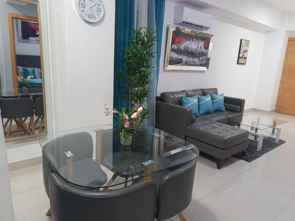 a living room with a couch and a glass table at Simply the most comfortable place next to Boca Chica beach in Boca Chica
