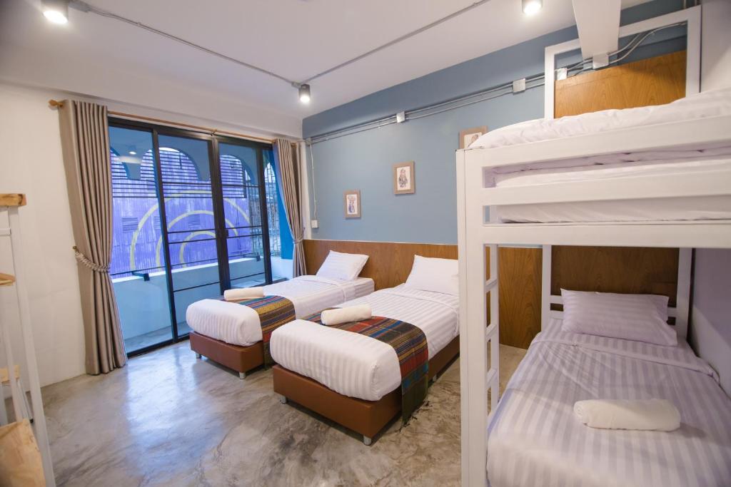 Postel nebo postele na pokoji v ubytování Suree House