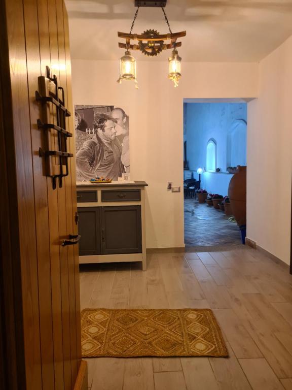 a hallway with a door and a kitchen with a table at Il Rifugio delle parole in Nuoro
