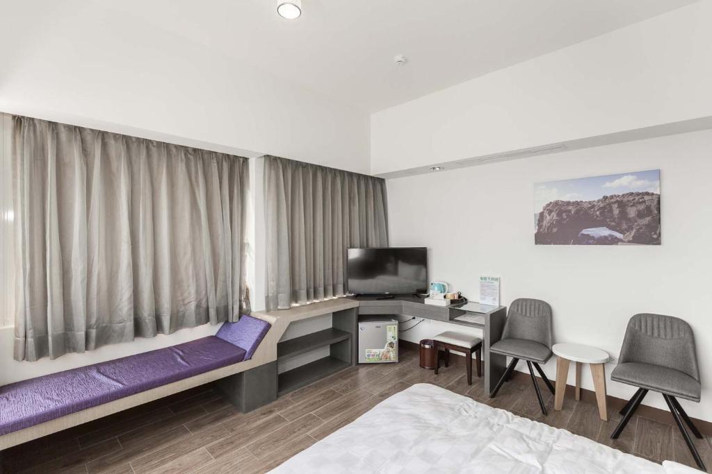 Postel nebo postele na pokoji v ubytování Tien Hsiang Lin Sea Dragon King Hotel