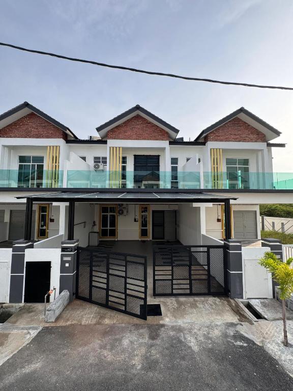 an image of a house with a garage at Meera Homestay in Malacca