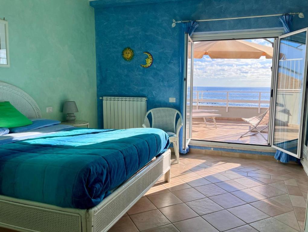 a bedroom with a bed and a view of the ocean at Casa MaTu in Nettuno