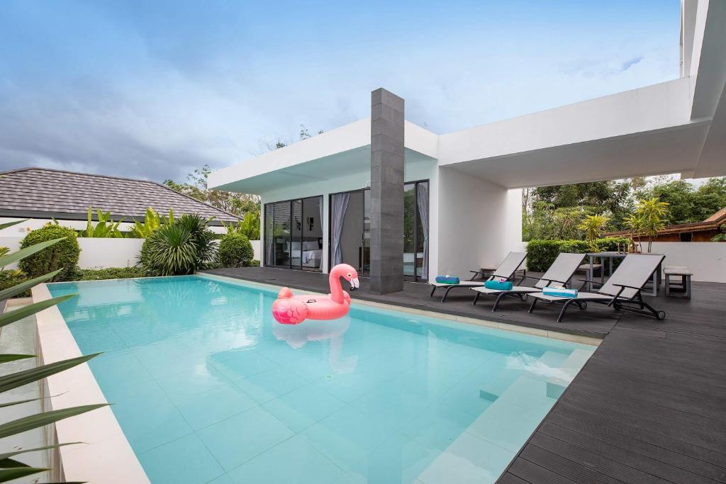 a swimming pool with a pink flamingo in a house at Luxury 6BR Villa with Private Pool in Bang Tao in Phuket