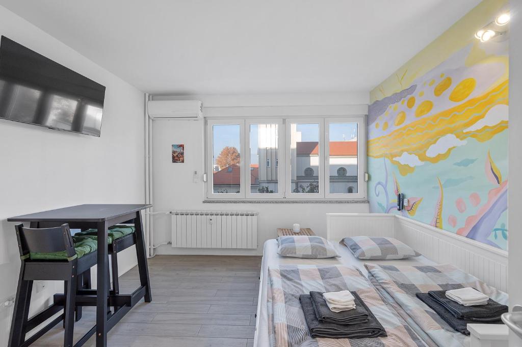 a small bedroom with a bed and a desk at Studio Apartment Pulse Zagreb Knezija in Zagreb