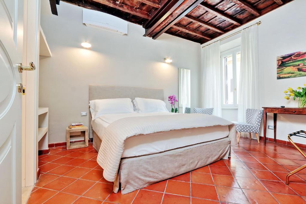 a bedroom with a bed and a red tile floor at Cancelleriadieci in Rome