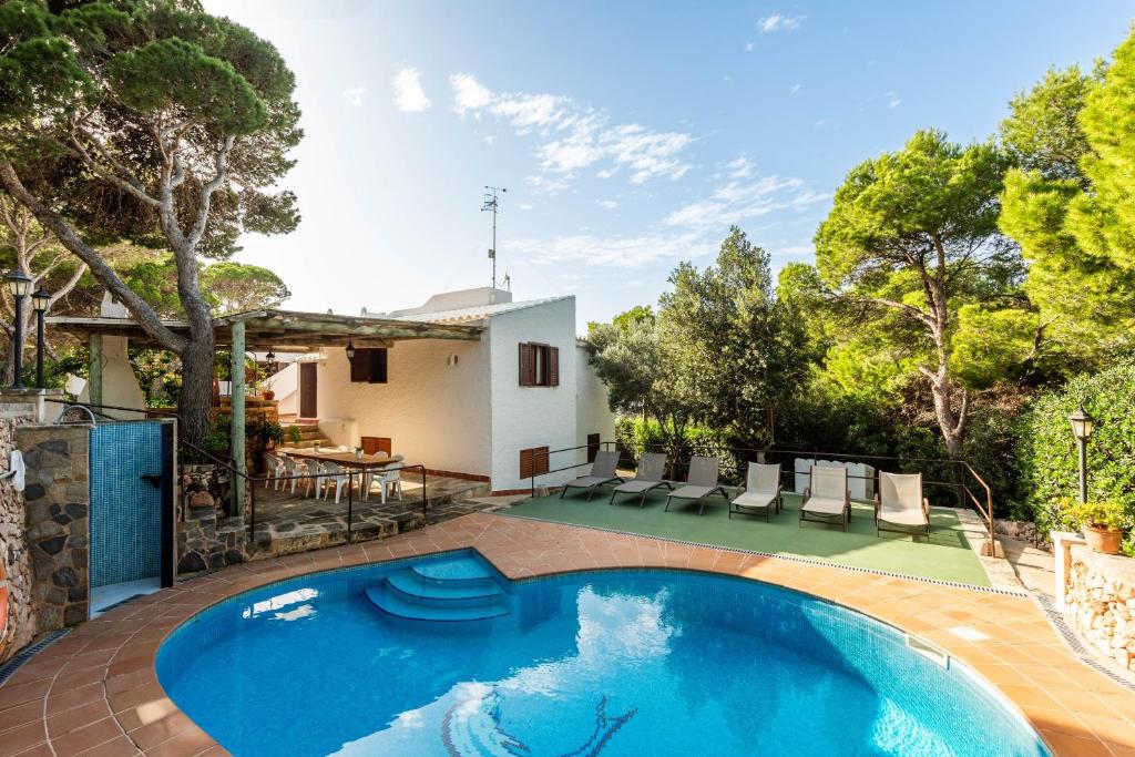 a swimming pool in the backyard of a house at Villa Can Biel by Escape Home in Cala Morell