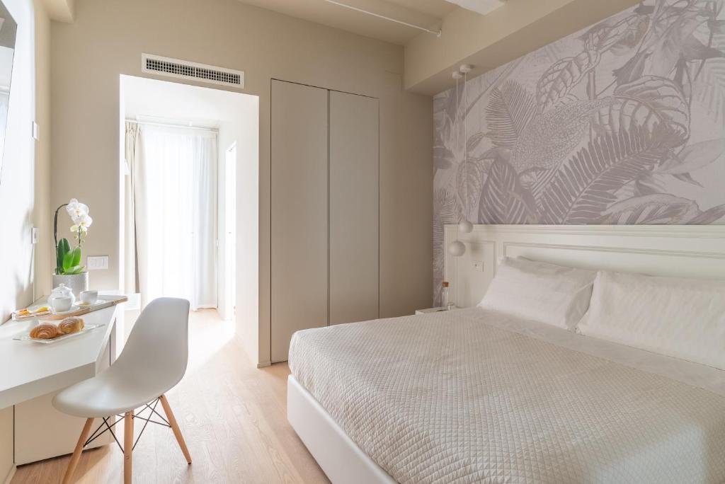 Postel nebo postele na pokoji v ubytování Dimora Bramante Rooms
