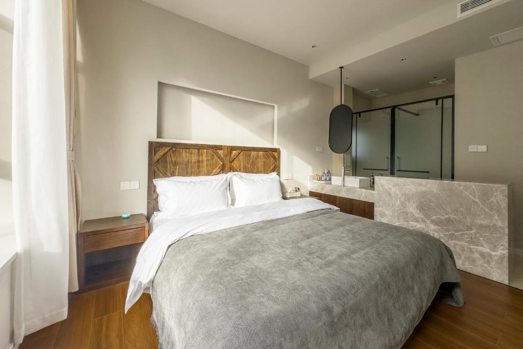 Postel nebo postele na pokoji v ubytování Shan Di B&B