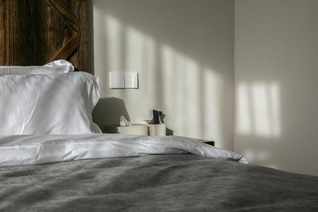 Postel nebo postele na pokoji v ubytování Shan Di B&B