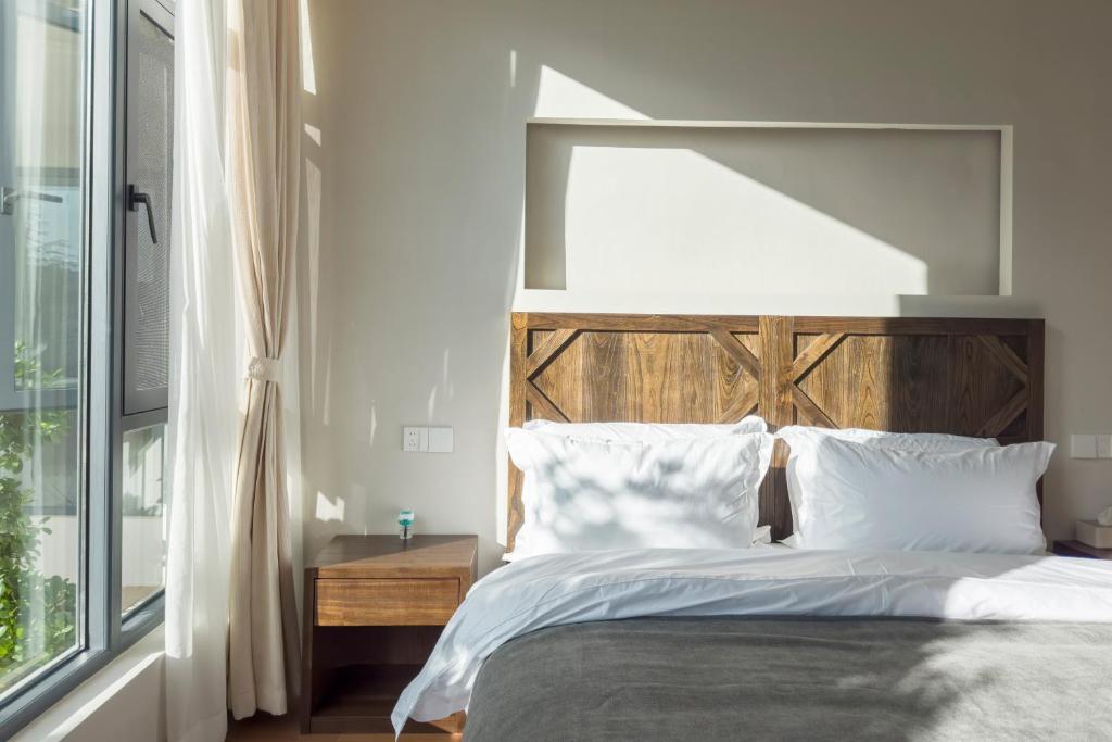 Postel nebo postele na pokoji v ubytování Shan Di B&B