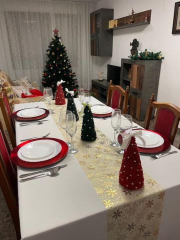 a dining table with a christmas tree in a room at Apartamento Diagonal in Nules