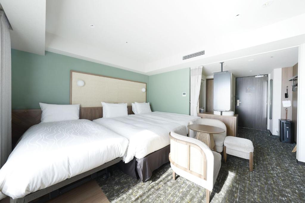 Postel nebo postele na pokoji v ubytování Keisei Richmond Hotel Tokyo Kinshicho